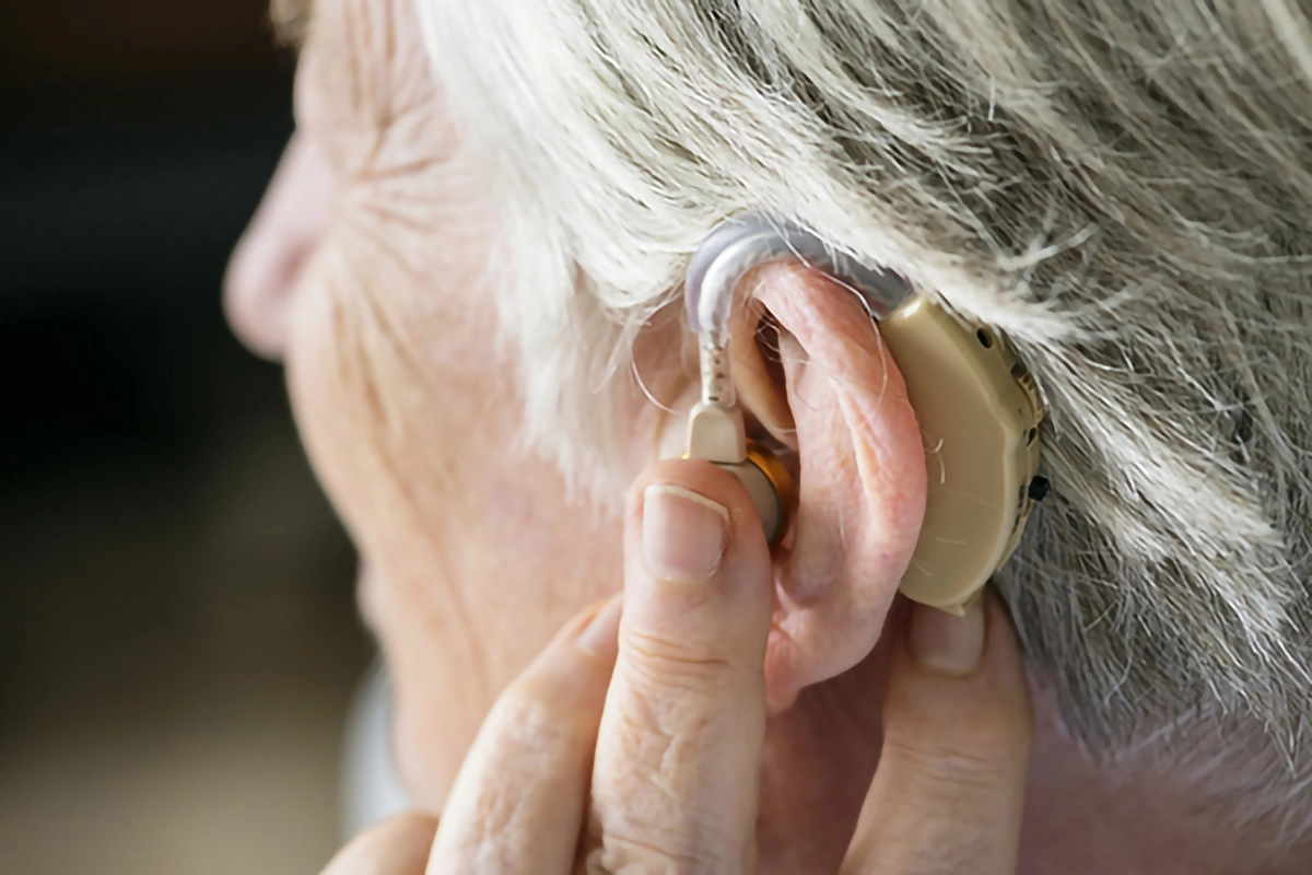 Image of someone using hearing help